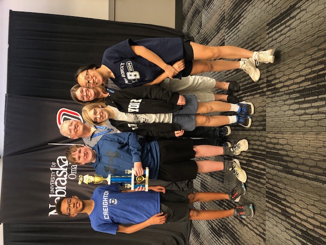  students and coaches stand for a picture with the third place trophy